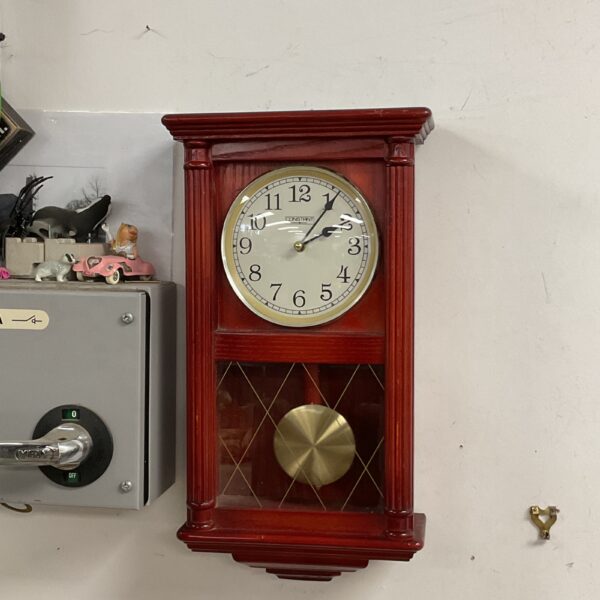 Vintage Constant quartz wall clock with Roman numerals and pendulum.