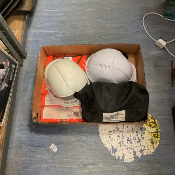 White construction helmets inside a cardboard box.