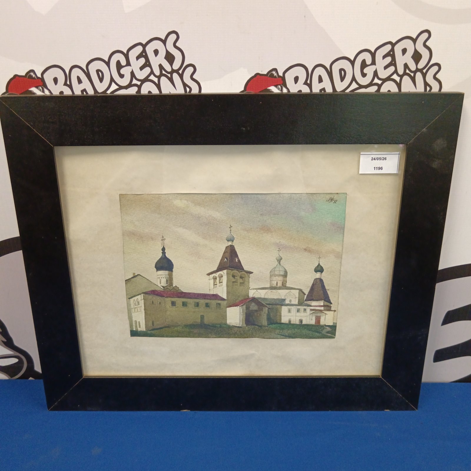 Signed watercolour painting of a continental church landscape.
