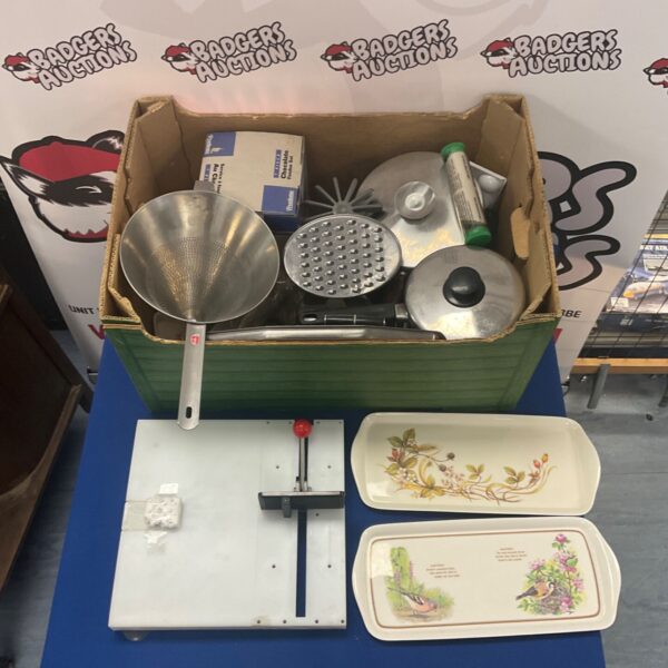 Stainless steel cookware set including sieve and saucepans.
