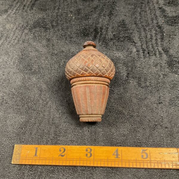 Antique 19th-century coquilla nut nutmeg grater with carved details.