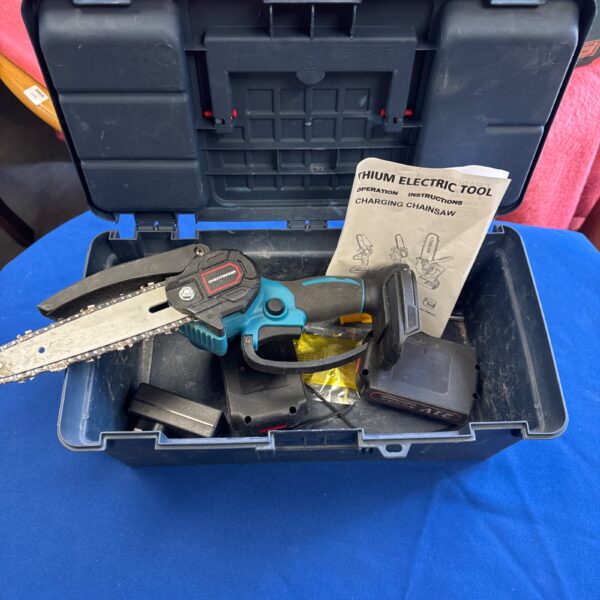 Cordless handheld chainsaw in a blue Tuffstuff toolbox.