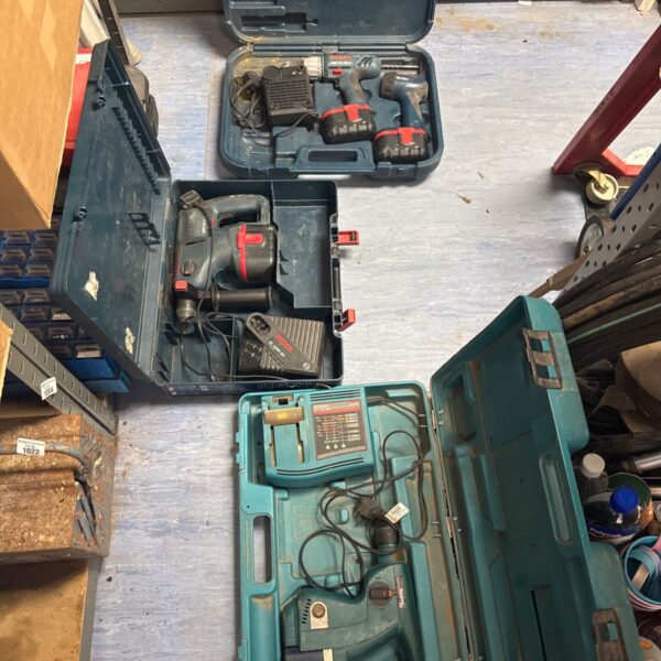 Cordless drill sets including Bosch and Makita in carrying cases.