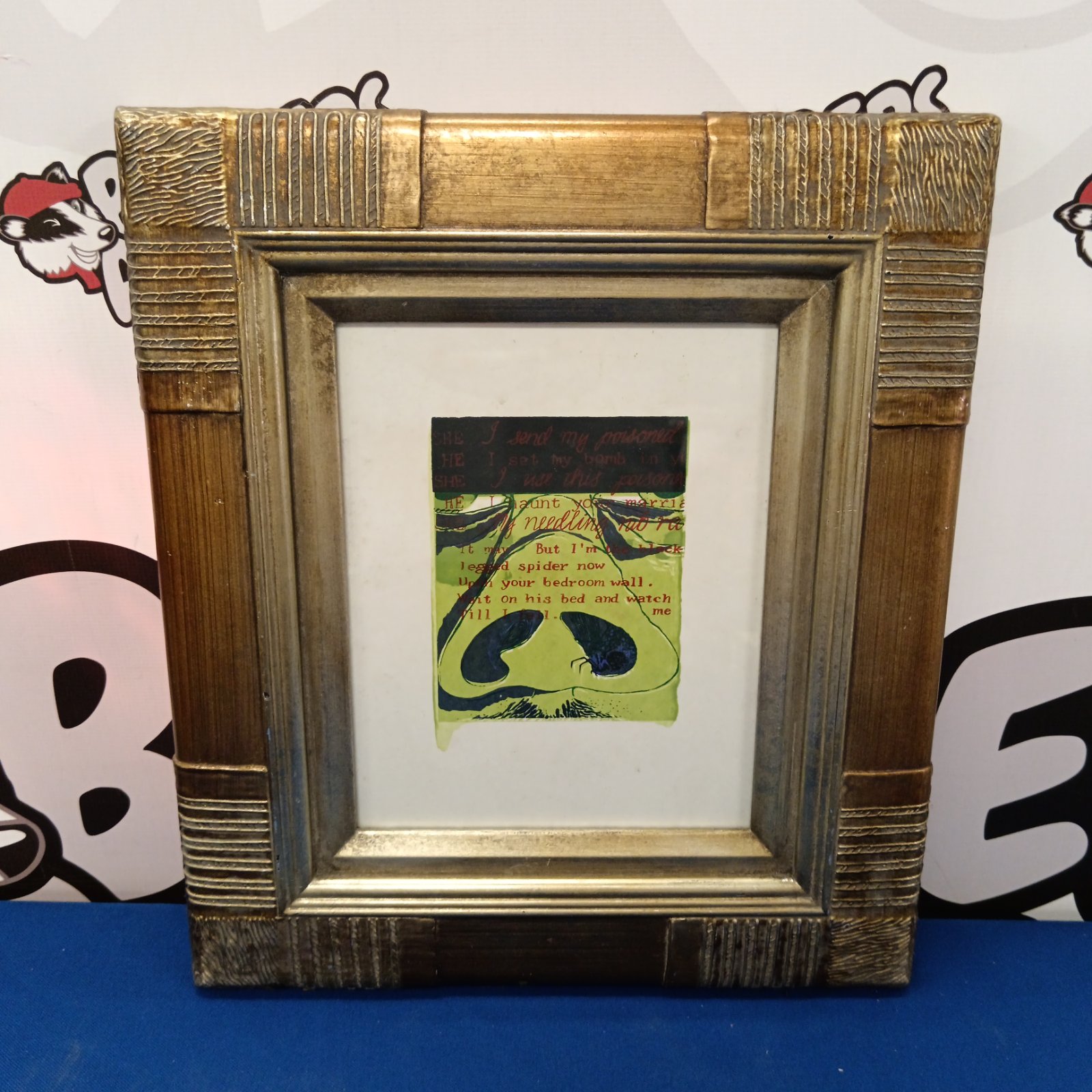 Framed Corita Kent aquatint print featuring a nose and poetic verse.