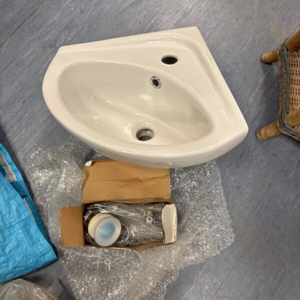 White ceramic corner basin sink for small bathrooms.