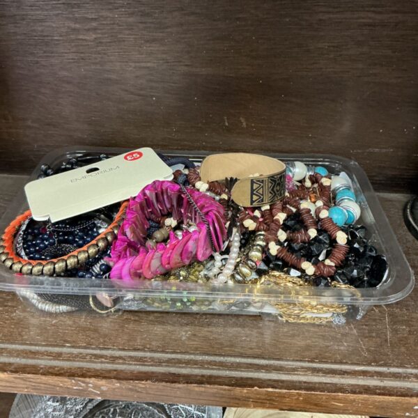 Tray of colourful costume jewellery with beaded necklaces and bracelets.