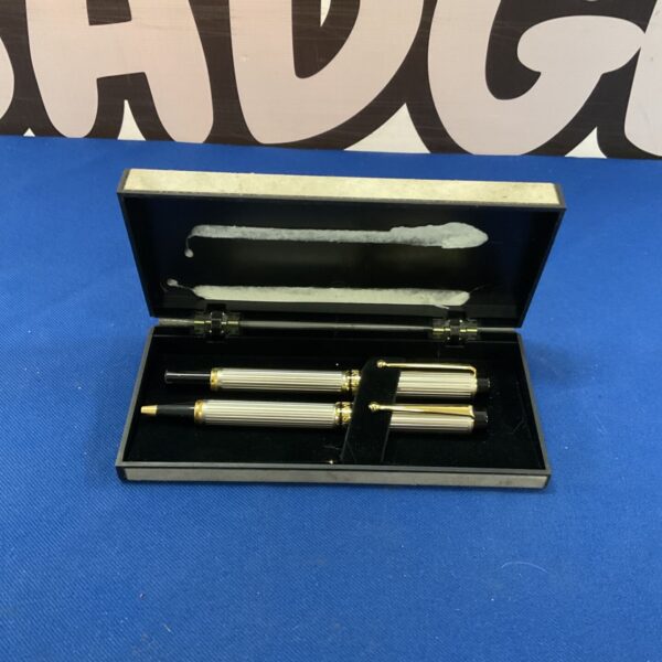 Closed Courvoisier pen set in black presentation case.