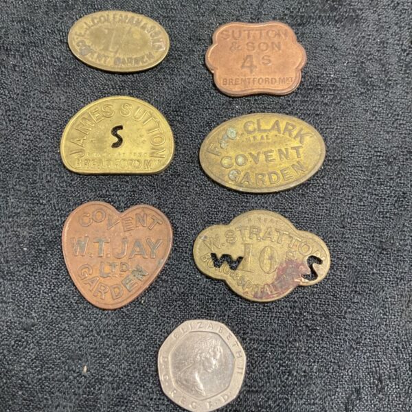 Group of vintage Covent Garden market tokens, brass and metal.