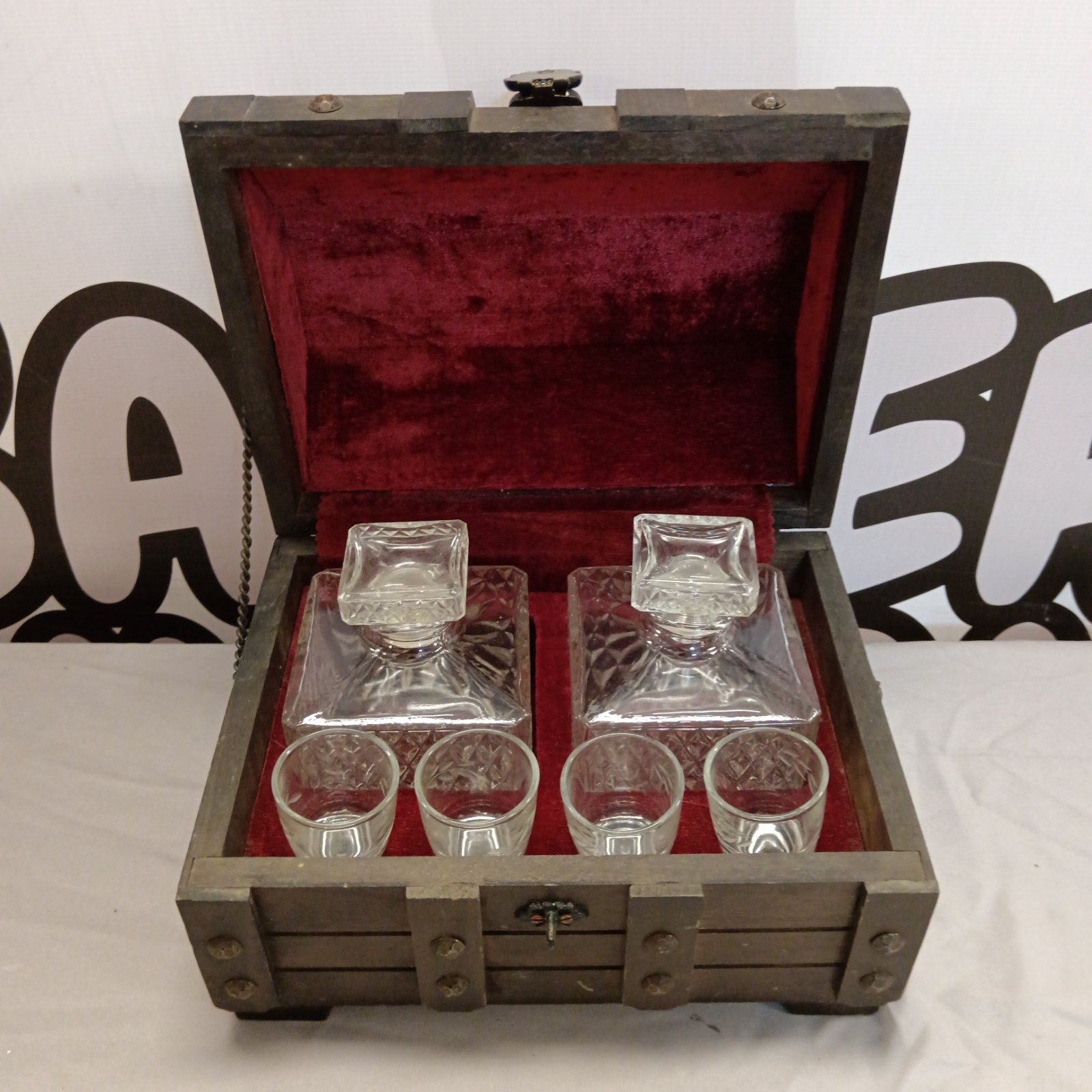 Vintage crystal decanter set displayed inside a wooden chest.