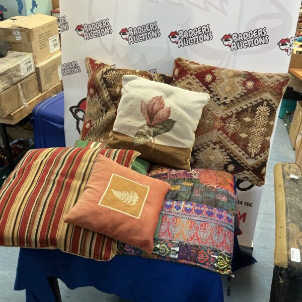 Floral patterned cushions collection on a blue surface.