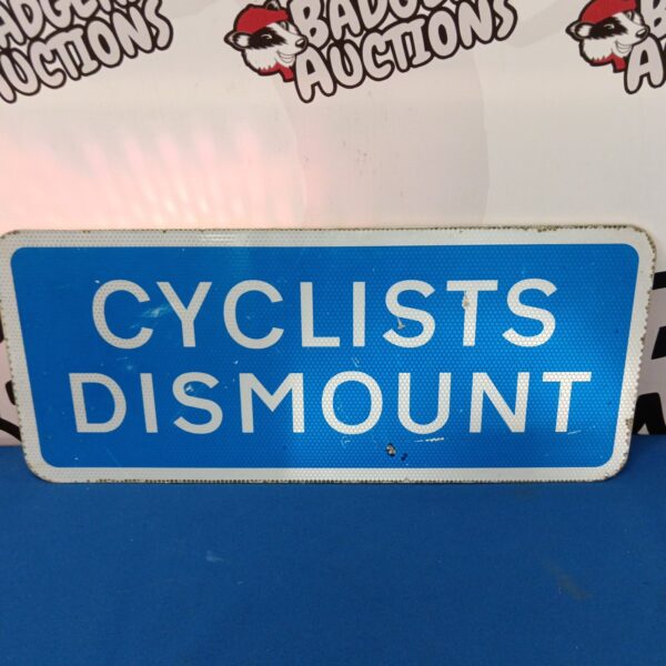 Vintage blue metal ‘Cyclists Dismount’ road sign for cyclists.