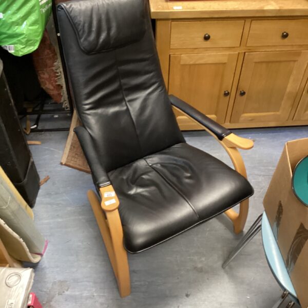 Stylish Danish designer chair with leather upholstery and wood frame.