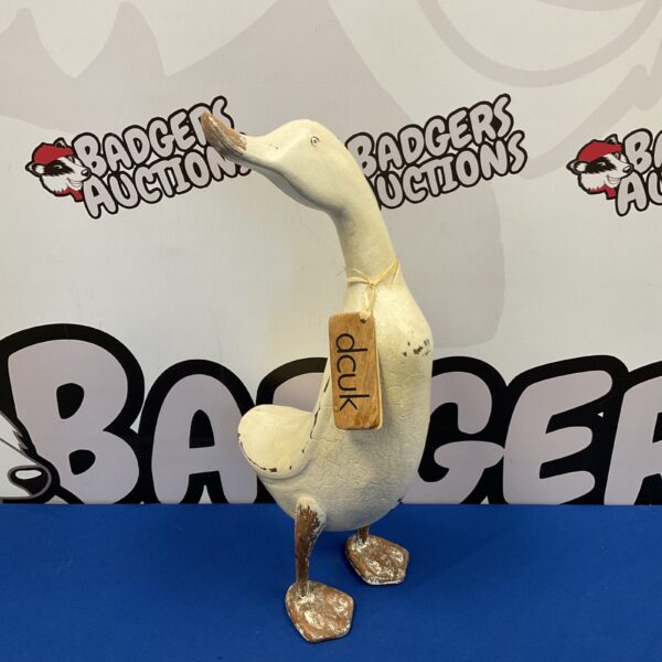 Dcuk wooden duck ‘Amy’ ornament against a backdrop.