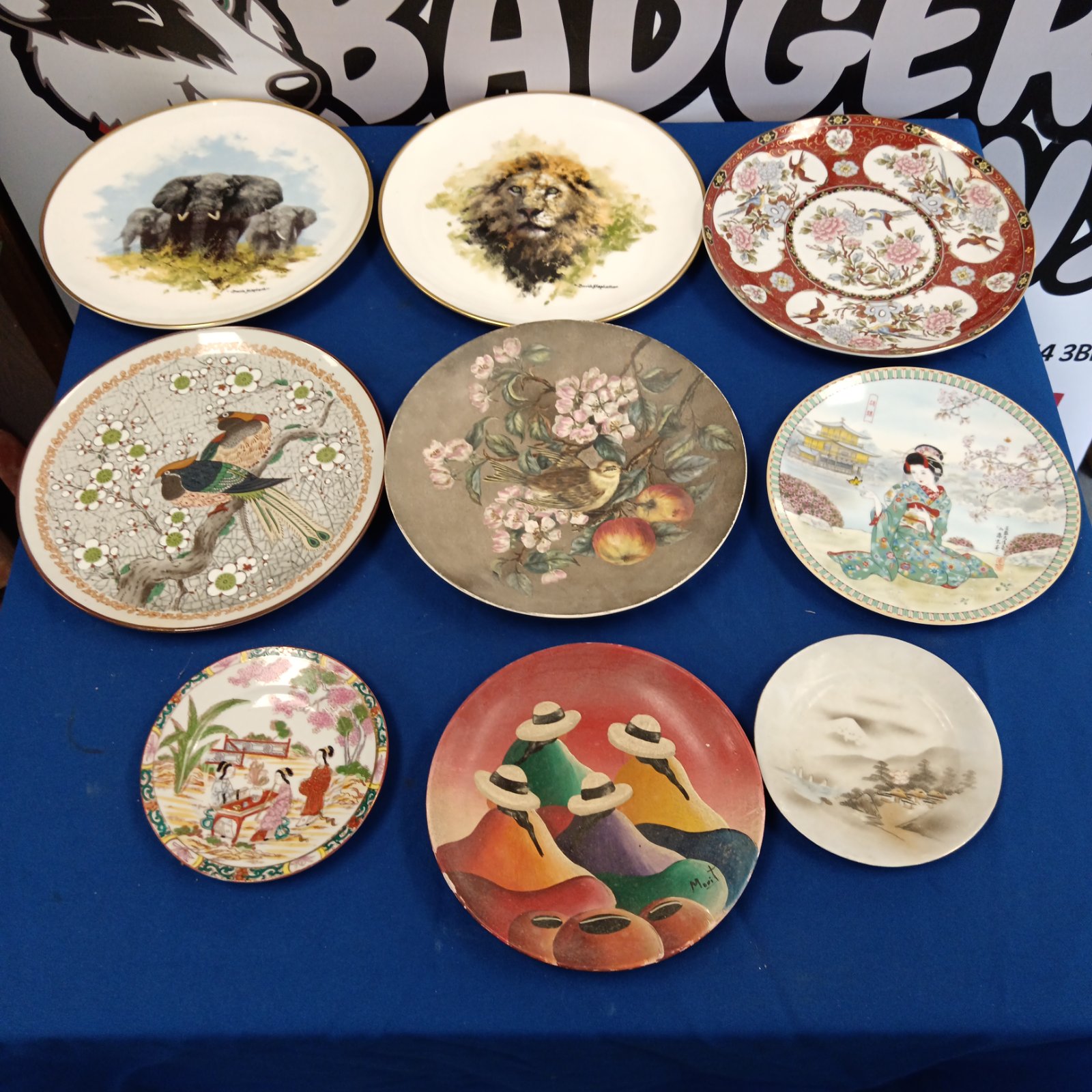 Collection of decorative plates including David Shepherd and Japanese designs.
