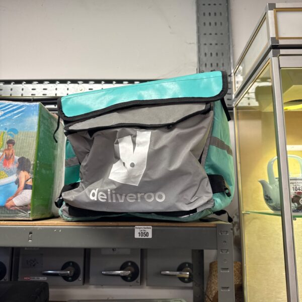 Front view of a used Deliveroo courier bag for food delivery.