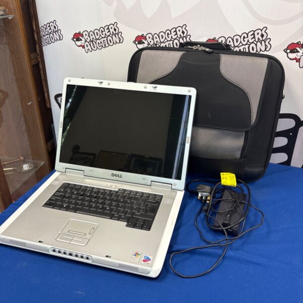 Dell PP14L laptop with charger and carrying bag displayed.