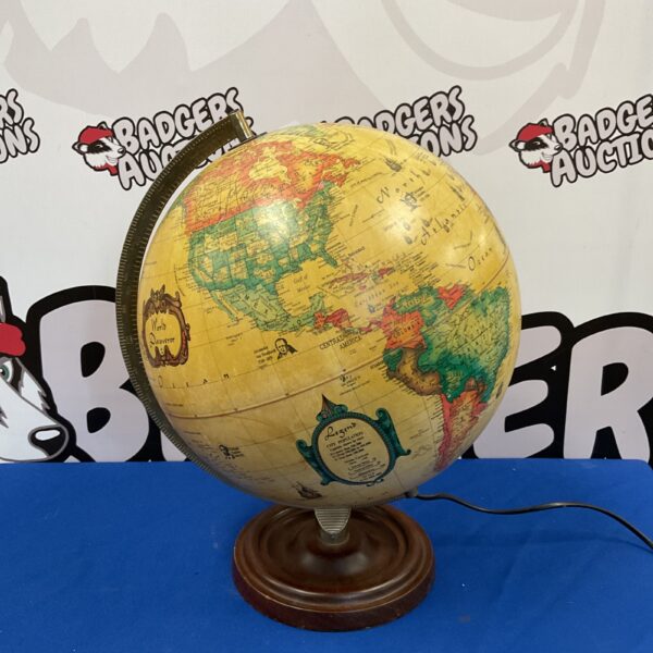 Illuminated desktop globe with detailed world map, vintage style.