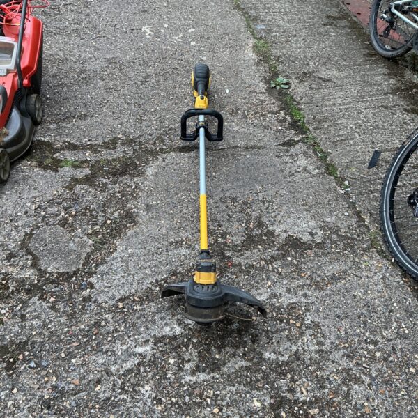 DeWalt cordless strimmer in a garden setting.