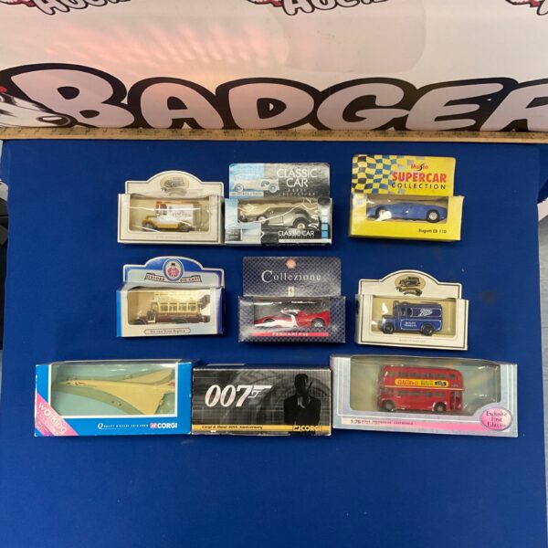 Diecast model cars lot featuring Corgi, Ferrari, and Bugatti vehicles.