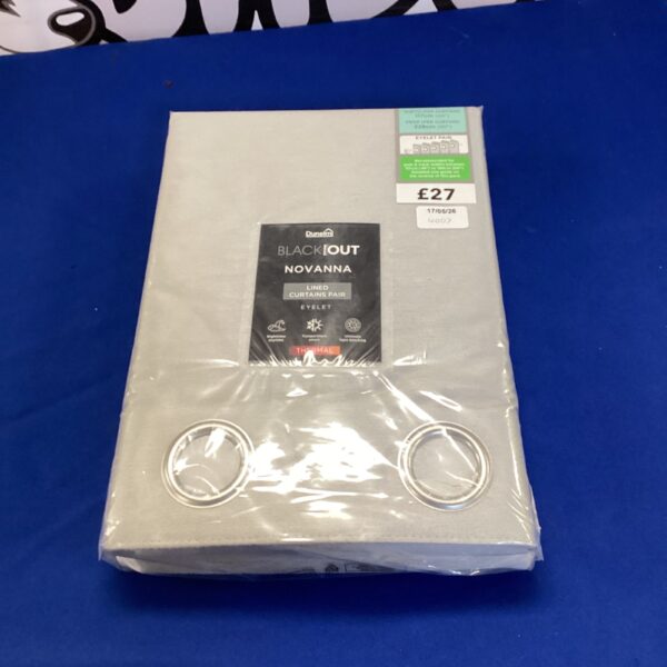 New pair of Dunelm Novana blackout curtains with price tag.