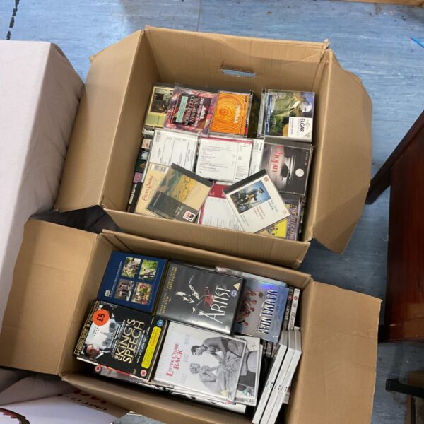 Large lot of assorted DVDs, CDs, and VHS tapes for collectors.