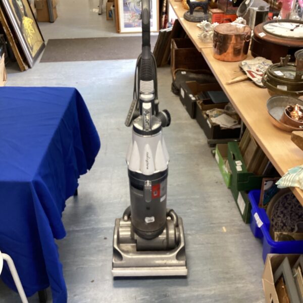 Vintage Dyson Root Cyclone vacuum cleaner in a home setting.
