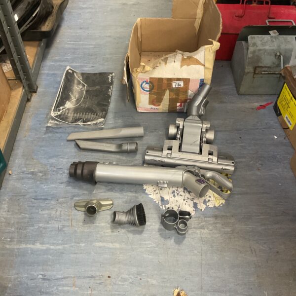 Dyson vacuum cleaner attachments including floor head and wand.