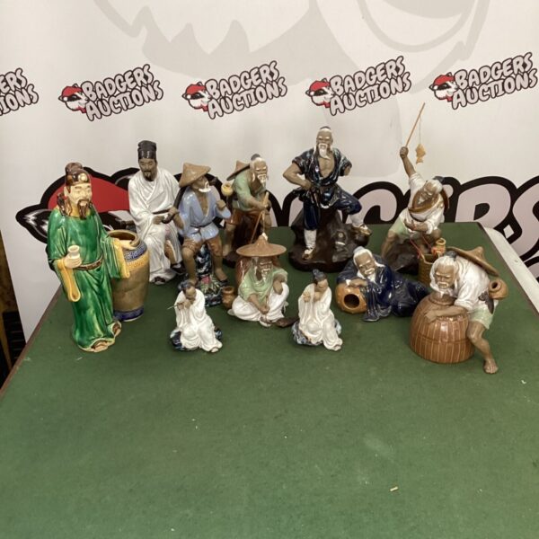 Collection of vintage East Asian china figurines on display.