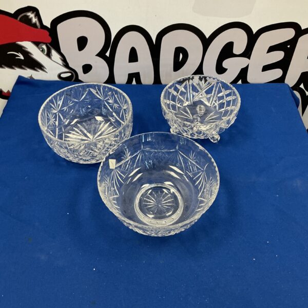 Set of three vintage Edinburgh Crystal fruit bowls on display.