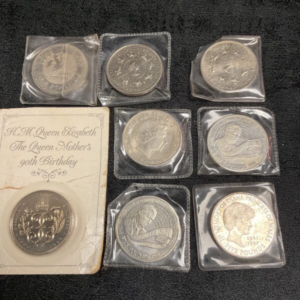 Eight £5 commemorative coins featuring Queen Elizabeth II.