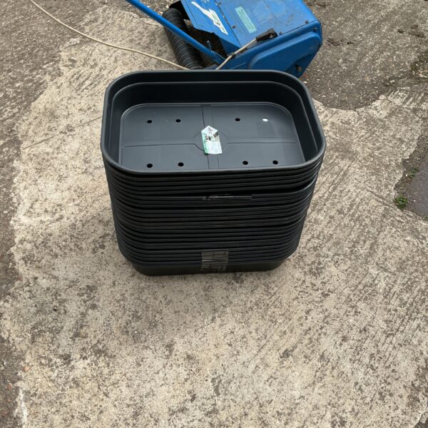 Lot of used Elho seed trays for garden plant propagation.