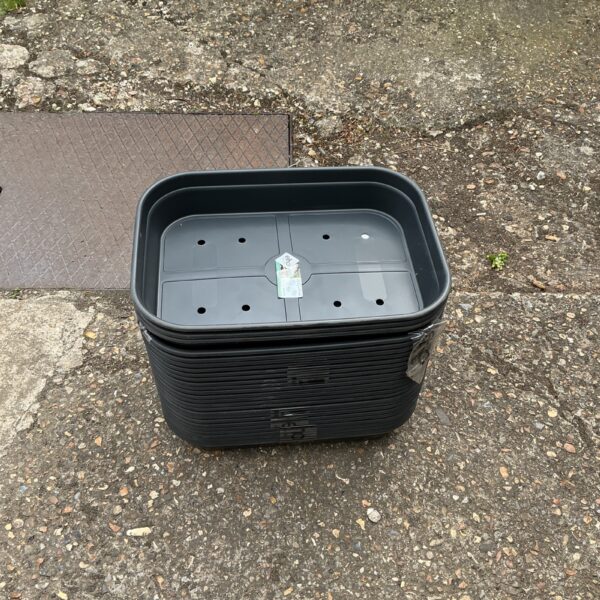 Lot of used Elho seed trays for gardening and plant propagation.