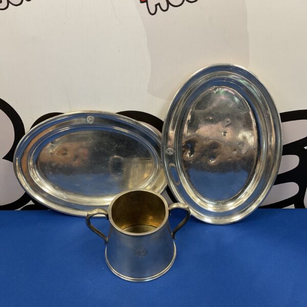 Antique Elkington silver plate tankard and plates set on display.