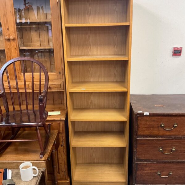 Light oak Ercol Windsor medium bookcase in a home setting.