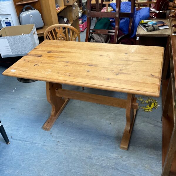 Rustic farmhouse kitchen table made of solid pine wood.