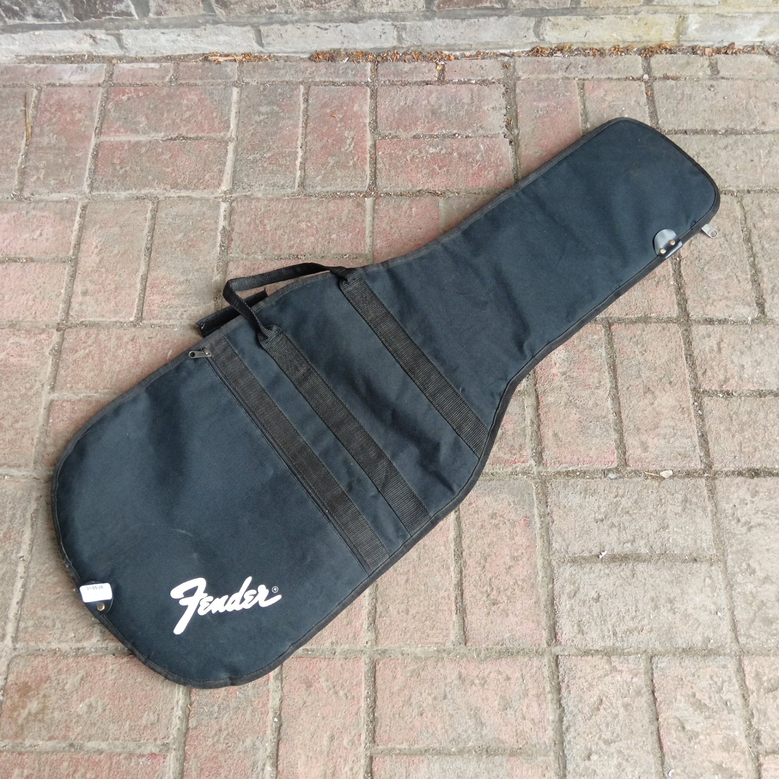 Black Fender guitar case with carry handle and zipper.