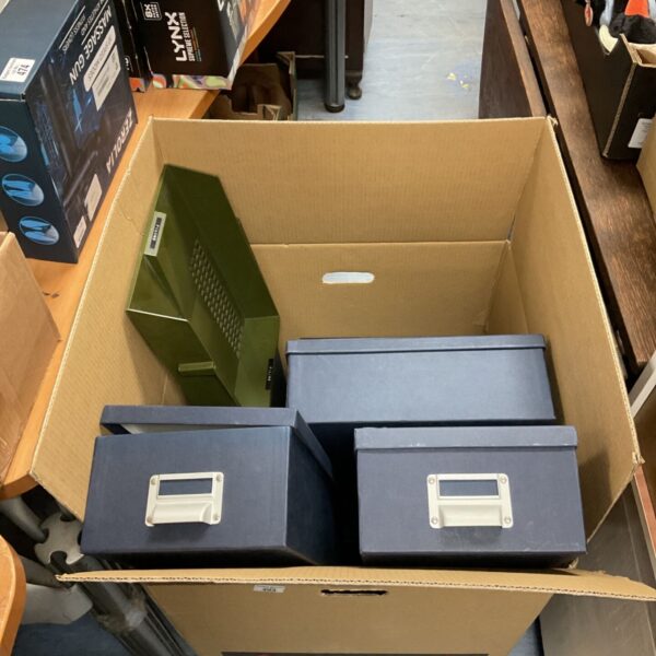 Dark blue filing boxes and green tray in a cardboard box.