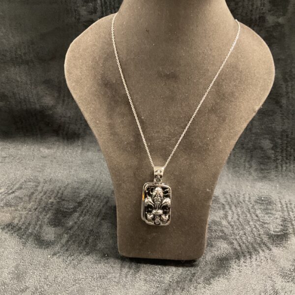 Silver tone Fleur de Lis pendant on 18 inch necklace.