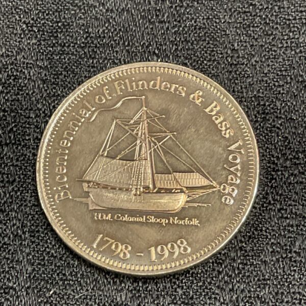 Silver commemorative medal of Flinders and Bass voyage with ship detail.