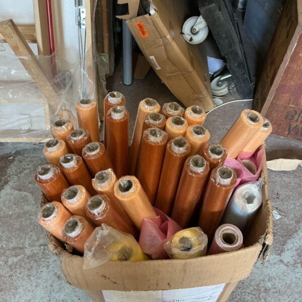 Box of colourful florist wrapping paper rolls for gifts.