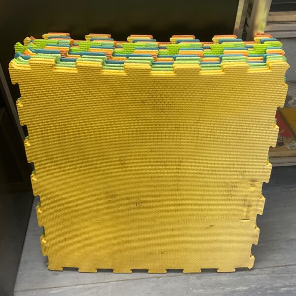 Brightly coloured foam floor tiles in a bundle for kids play areas.