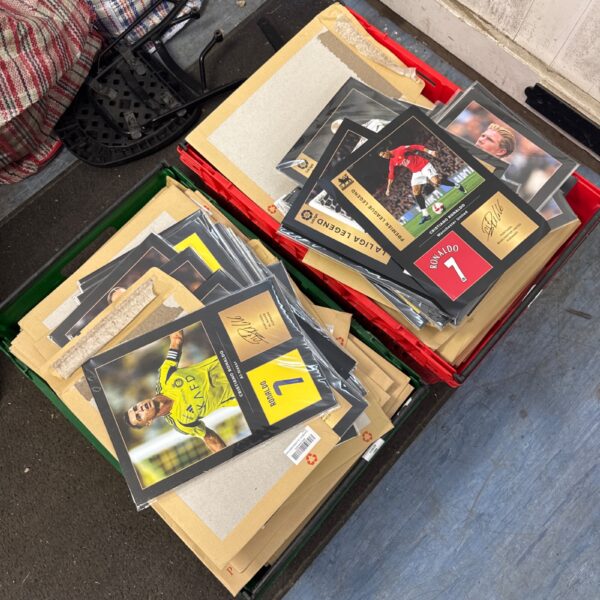Crate filled with footballer prints and card backed envelopes.