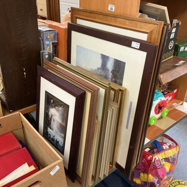 Lot of assorted framed artwork and vintage paintings on display.