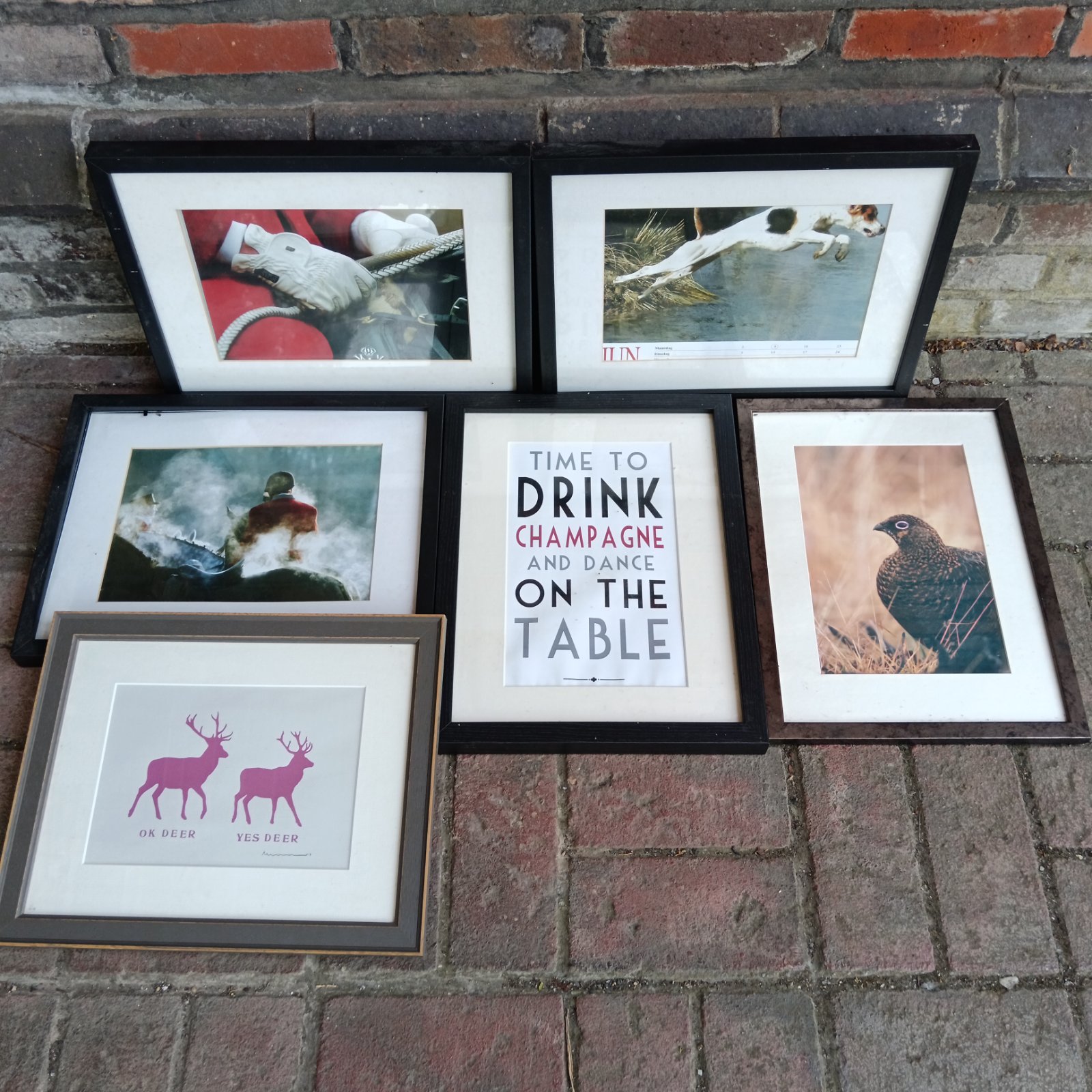 Framed vintage print of horses in a hunting scene.