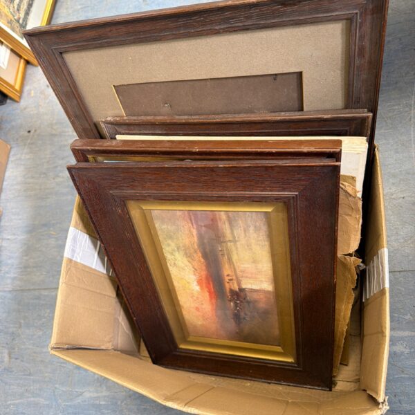 Mixed lot of vintage framed paintings in a cardboard box.