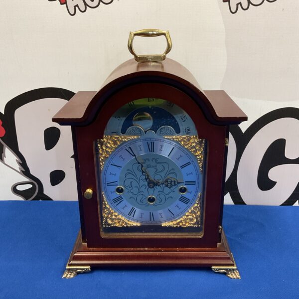 Front view of a Franz Hermle mantle clock with a moon dial.