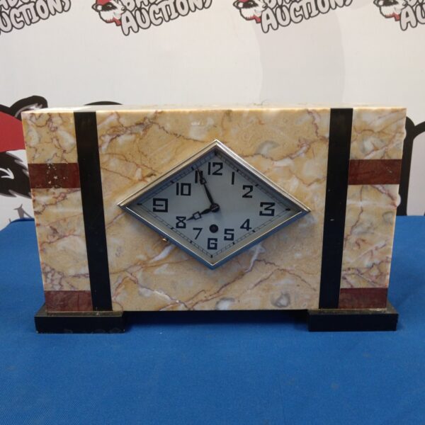 Vintage French marble mantle clock with diamond-shaped face.