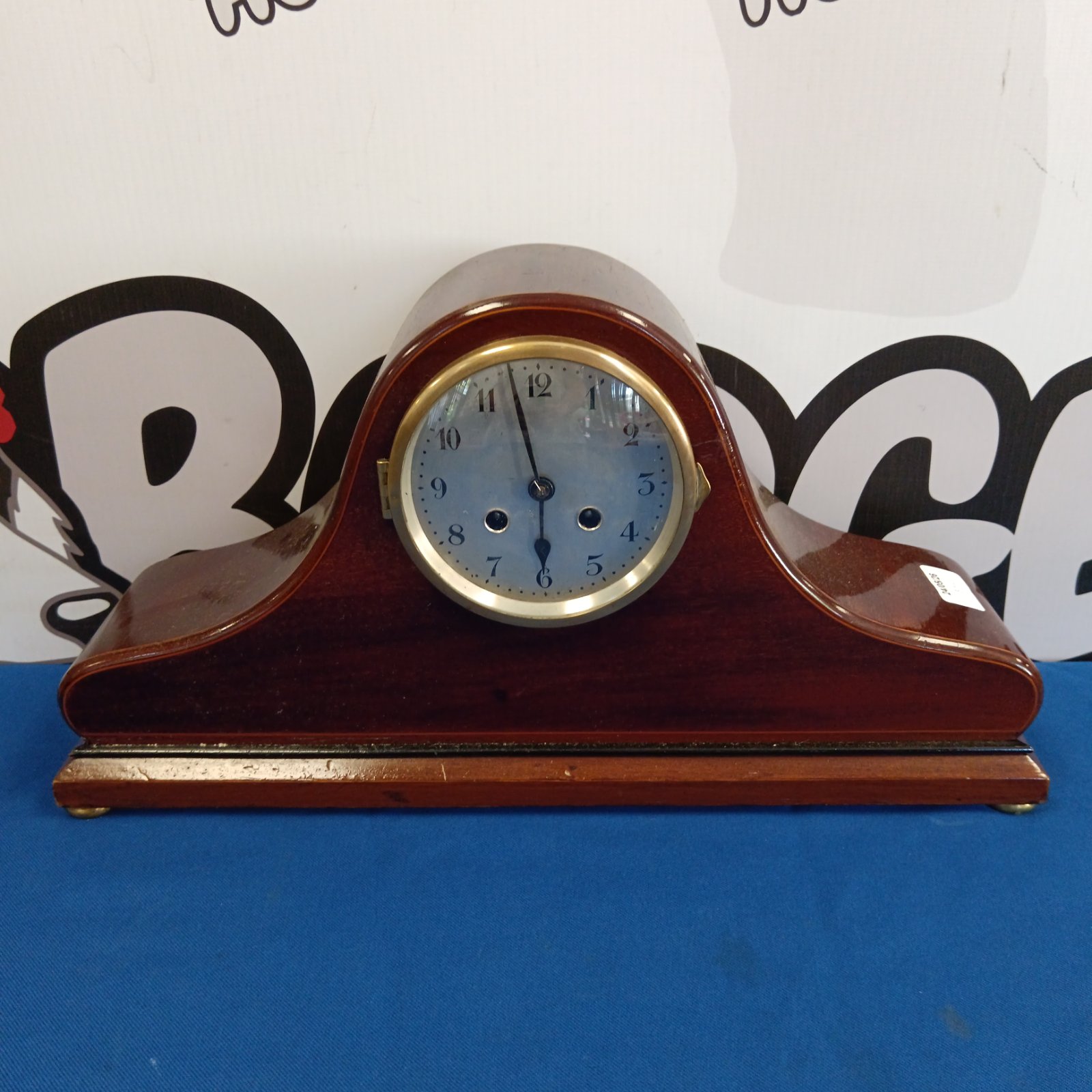 Vintage French Napoleon mantle clock with mahogany case and blue face.