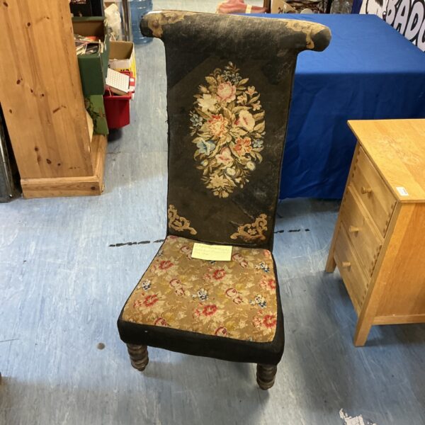 Antique French tapestry prayer chair with floral design.