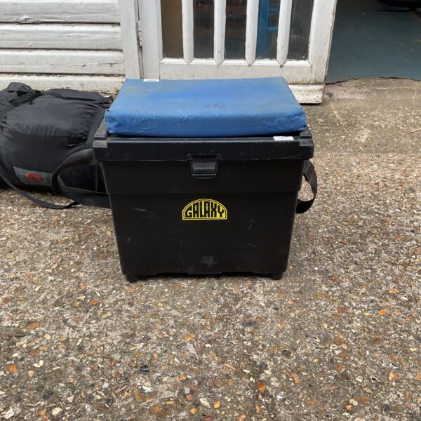 Black Galaxy fishing seat box with padded seat, angling equipment.